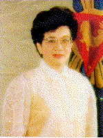 Color waist-up photo of Corazon Aquino with Philippine flag in background