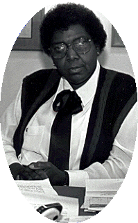 BW photo of Barbara Jordan sitting behind a desk